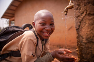 african-schoolboy-at-school-smiles-drinking-water-2023-11-27-05-03-49-utc (1)